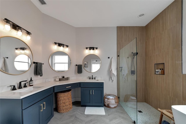 bathroom featuring vanity and shower with separate bathtub