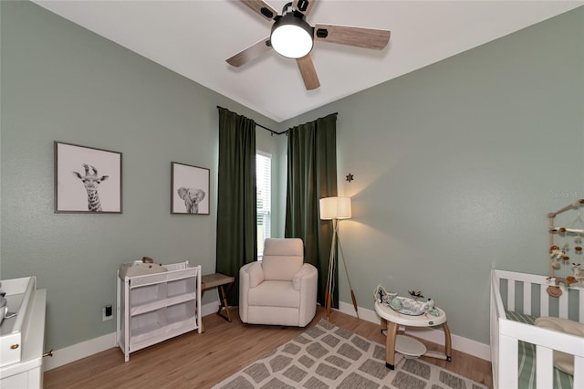 living area with ceiling fan and light hardwood / wood-style floors