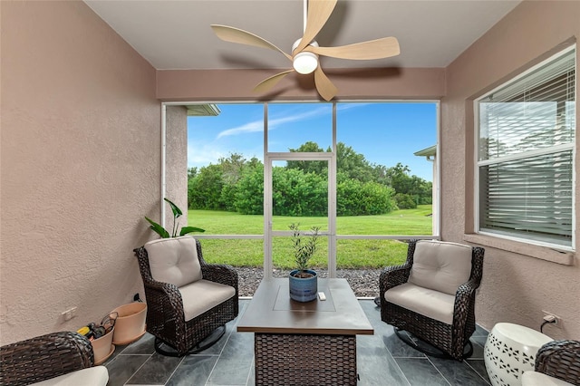 sunroom with ceiling fan