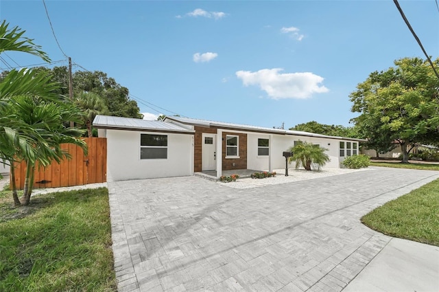 ranch-style home with a front yard