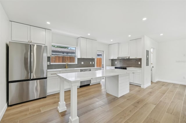 kitchen with white cabinetry, a center island, light hardwood / wood-style floors, and appliances with stainless steel finishes