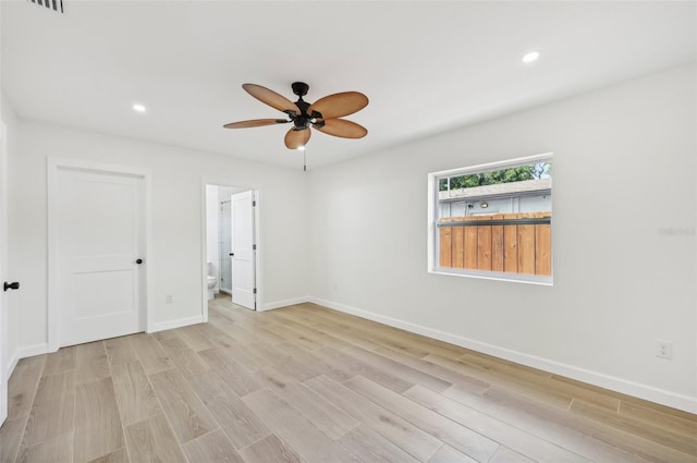 empty room featuring ceiling fan and light wood-type flooring