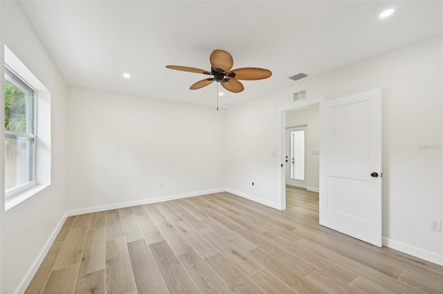 empty room with ceiling fan and light wood-type flooring