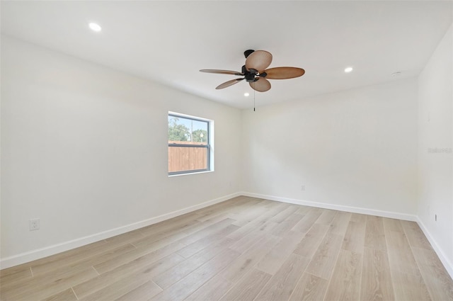 empty room featuring ceiling fan and light hardwood / wood-style flooring