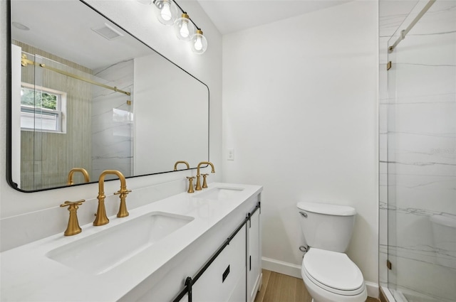 bathroom with vanity, wood-type flooring, an enclosed shower, and toilet