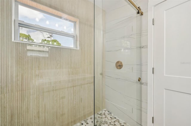 bathroom with a shower with door