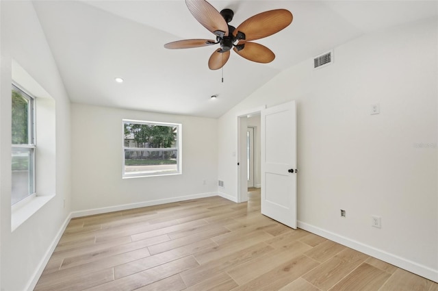 spare room featuring light hardwood / wood-style floors, ceiling fan, and lofted ceiling