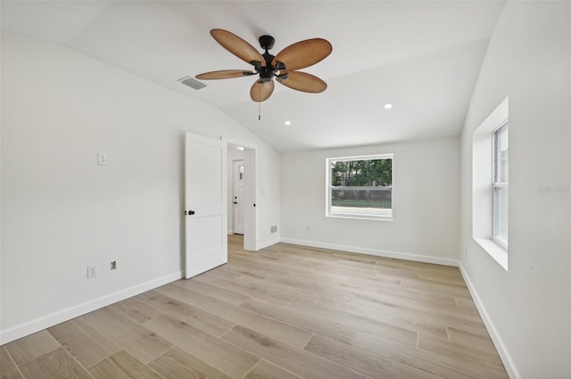 spare room with light hardwood / wood-style floors, ceiling fan, and lofted ceiling