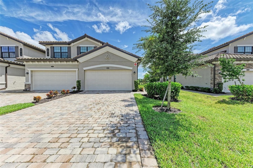 view of front of house with a garage and a front yard