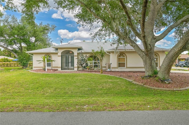 single story home featuring fence, a front lawn, and stucco siding