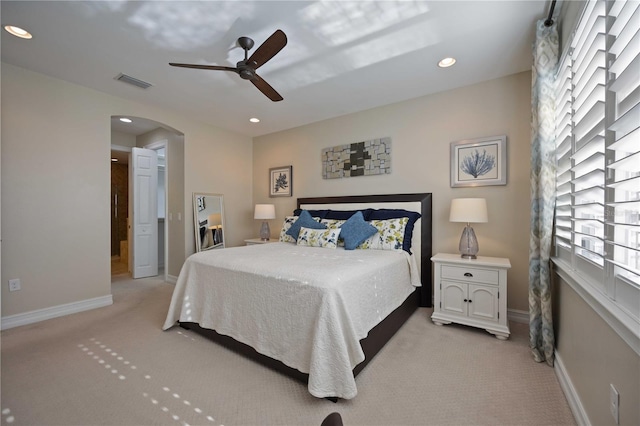 bedroom featuring light colored carpet and ceiling fan