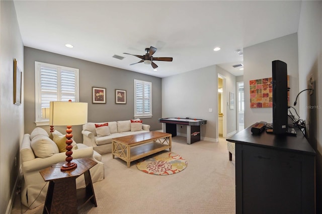 living room featuring light colored carpet and ceiling fan