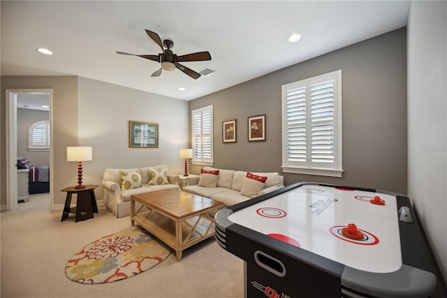 game room with ceiling fan and light carpet