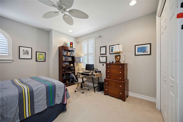 carpeted bedroom featuring a closet and ceiling fan