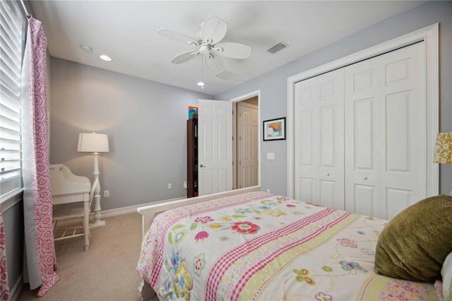 bedroom with multiple windows, carpet floors, ceiling fan, and a closet