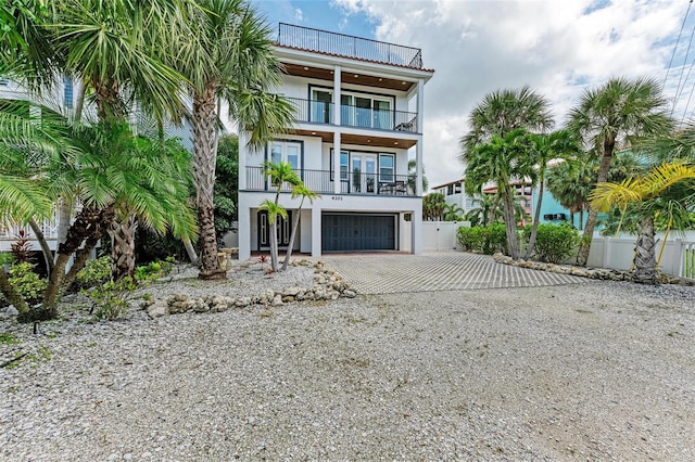 view of front of property featuring a garage and a balcony