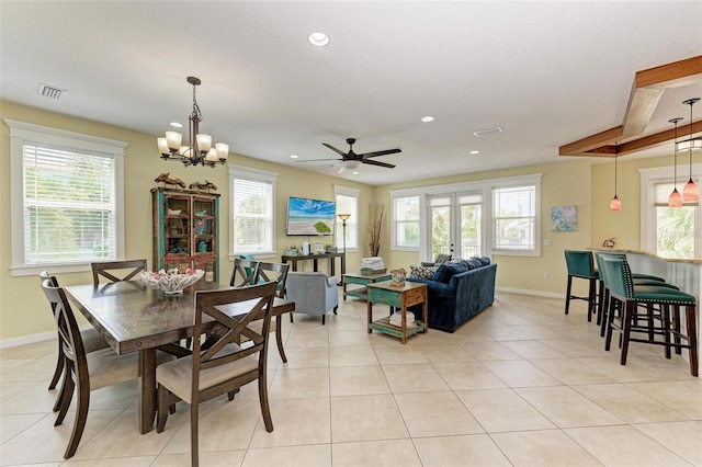 tiled dining space with ceiling fan with notable chandelier