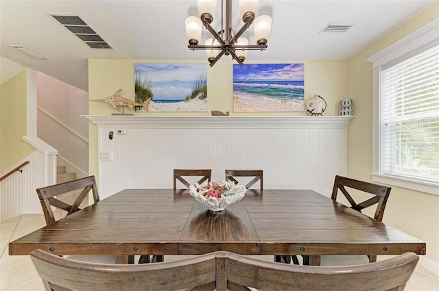 dining area with a notable chandelier, a healthy amount of sunlight, and light tile patterned flooring