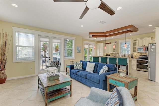 living room with ceiling fan, light tile patterned floors, sink, and french doors