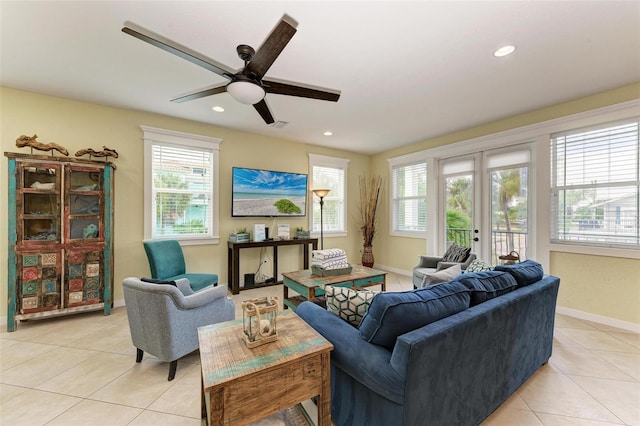 tiled living room featuring french doors, plenty of natural light, and ceiling fan