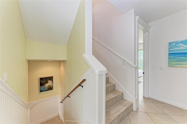 stairway featuring tile patterned flooring