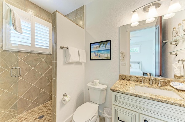 bathroom featuring vanity, toilet, and a shower with shower door