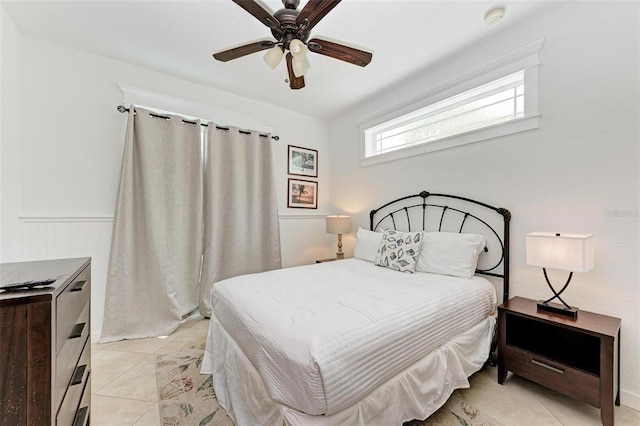 bedroom featuring light tile patterned floors and ceiling fan