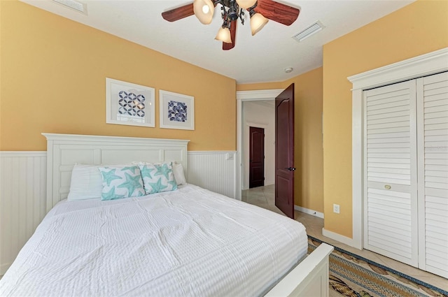 tiled bedroom featuring a closet and ceiling fan