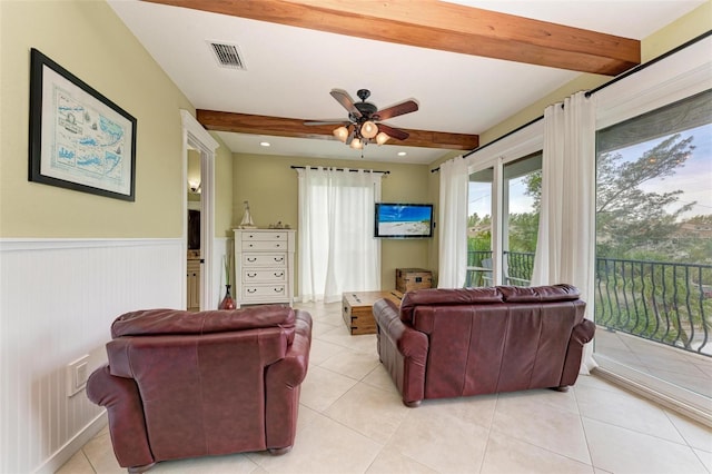 tiled living room featuring ceiling fan and beamed ceiling