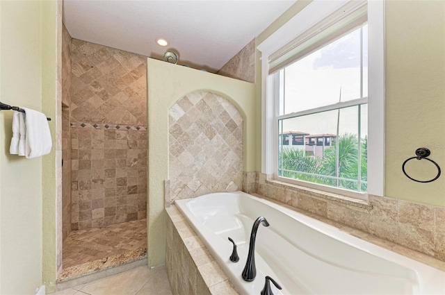 bathroom with tile patterned flooring, independent shower and bath, and a textured ceiling