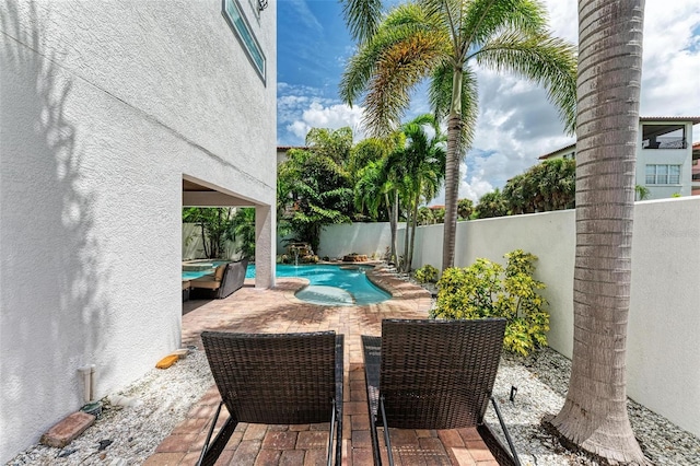 view of patio / terrace with a fenced in pool