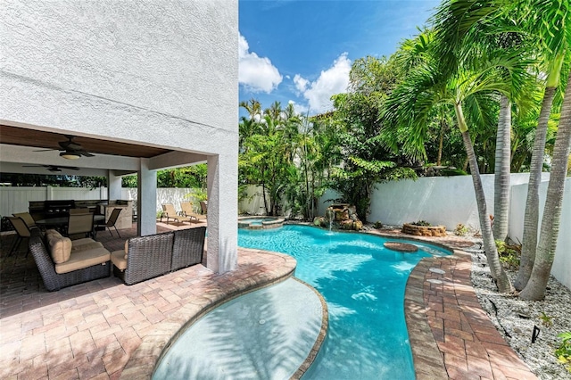 view of pool with ceiling fan and a patio area