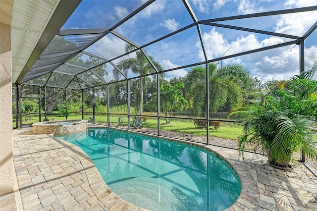 view of swimming pool featuring an in ground hot tub, glass enclosure, and a patio area