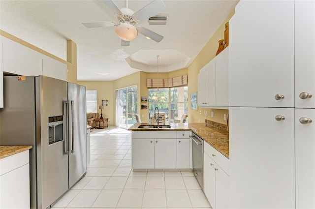 kitchen with white cabinetry, sink, stainless steel appliances, kitchen peninsula, and a textured ceiling