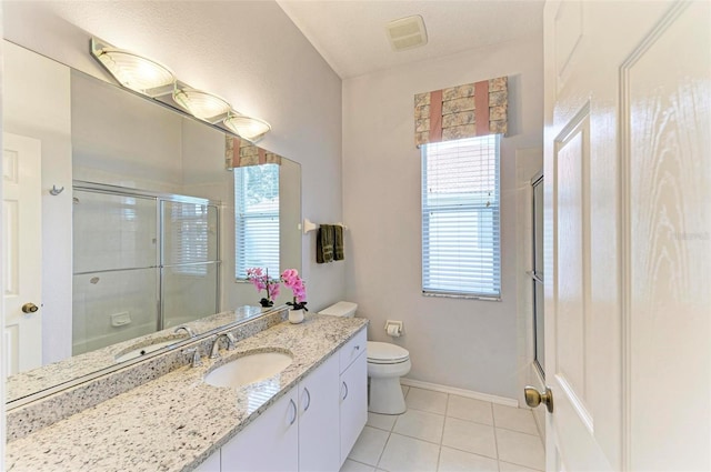 bathroom with tile patterned flooring, vanity, toilet, and a shower with door