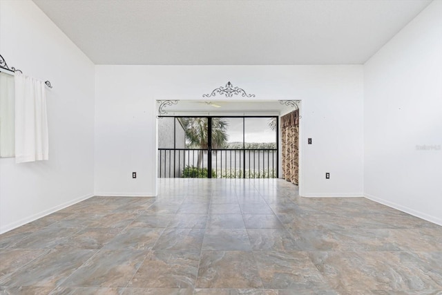 empty room featuring baseboards