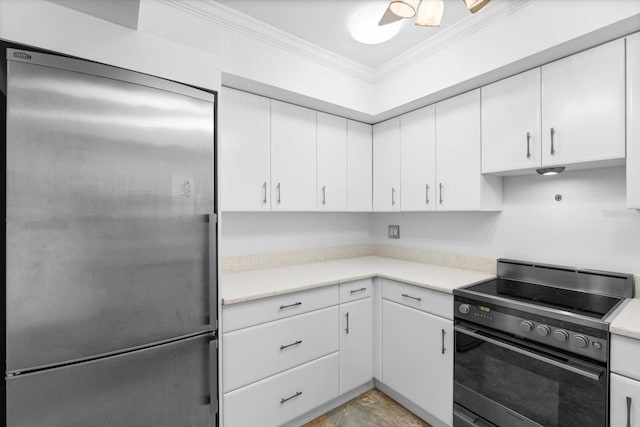 kitchen featuring light countertops, black range with electric stovetop, ornamental molding, white cabinets, and built in refrigerator