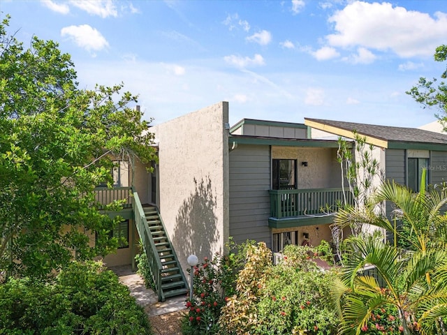 view of front of home featuring stairs and stucco siding