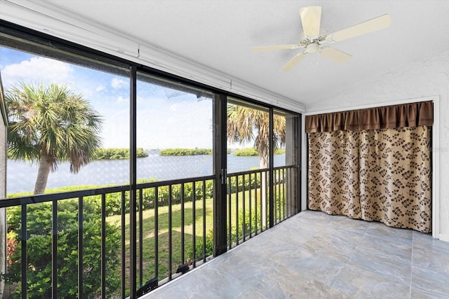 unfurnished sunroom featuring a ceiling fan, lofted ceiling, and a water view