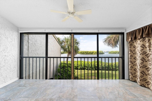 unfurnished sunroom featuring a water view and ceiling fan