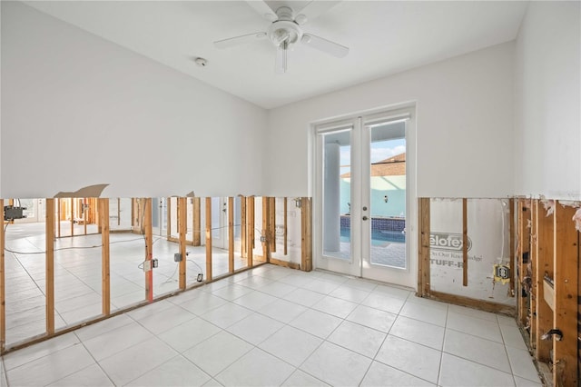 spare room with ceiling fan, light tile patterned flooring, and french doors