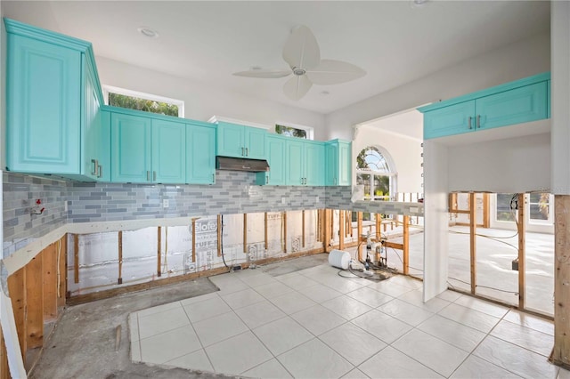 kitchen featuring blue cabinets, a healthy amount of sunlight, and ceiling fan