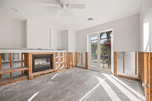 unfurnished living room with ceiling fan