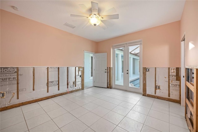 spare room featuring ceiling fan and light tile patterned floors