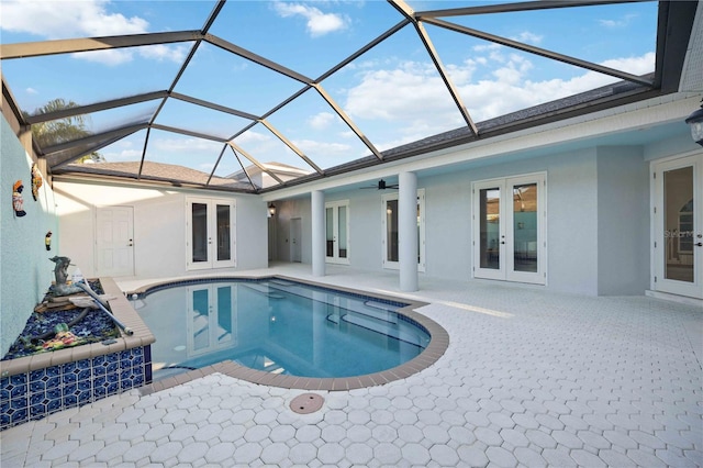 view of pool featuring ceiling fan, a patio area, glass enclosure, and french doors