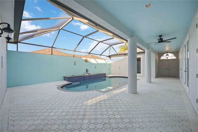 view of swimming pool featuring glass enclosure, a patio area, and ceiling fan