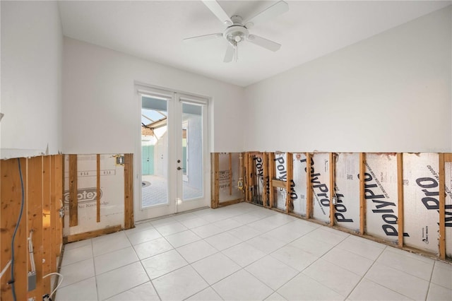 tiled spare room featuring ceiling fan