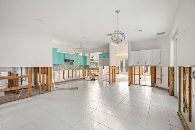 unfurnished room featuring light tile patterned floors and an inviting chandelier