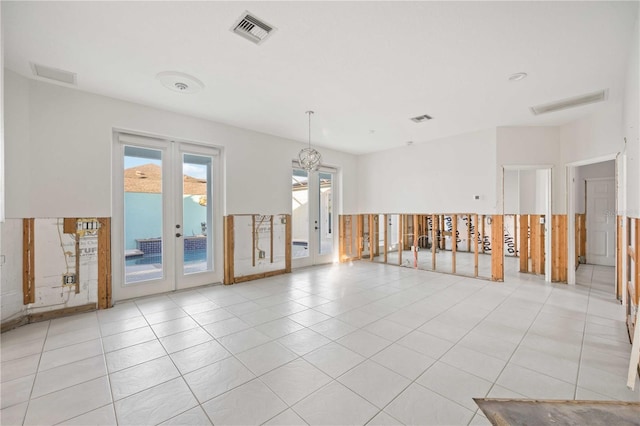 tiled spare room with french doors