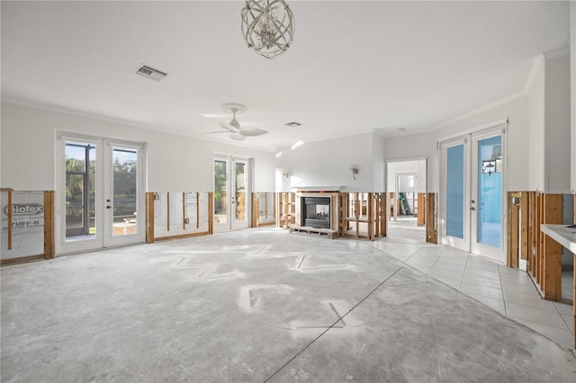 unfurnished living room featuring ornamental molding, french doors, light tile patterned flooring, and ceiling fan